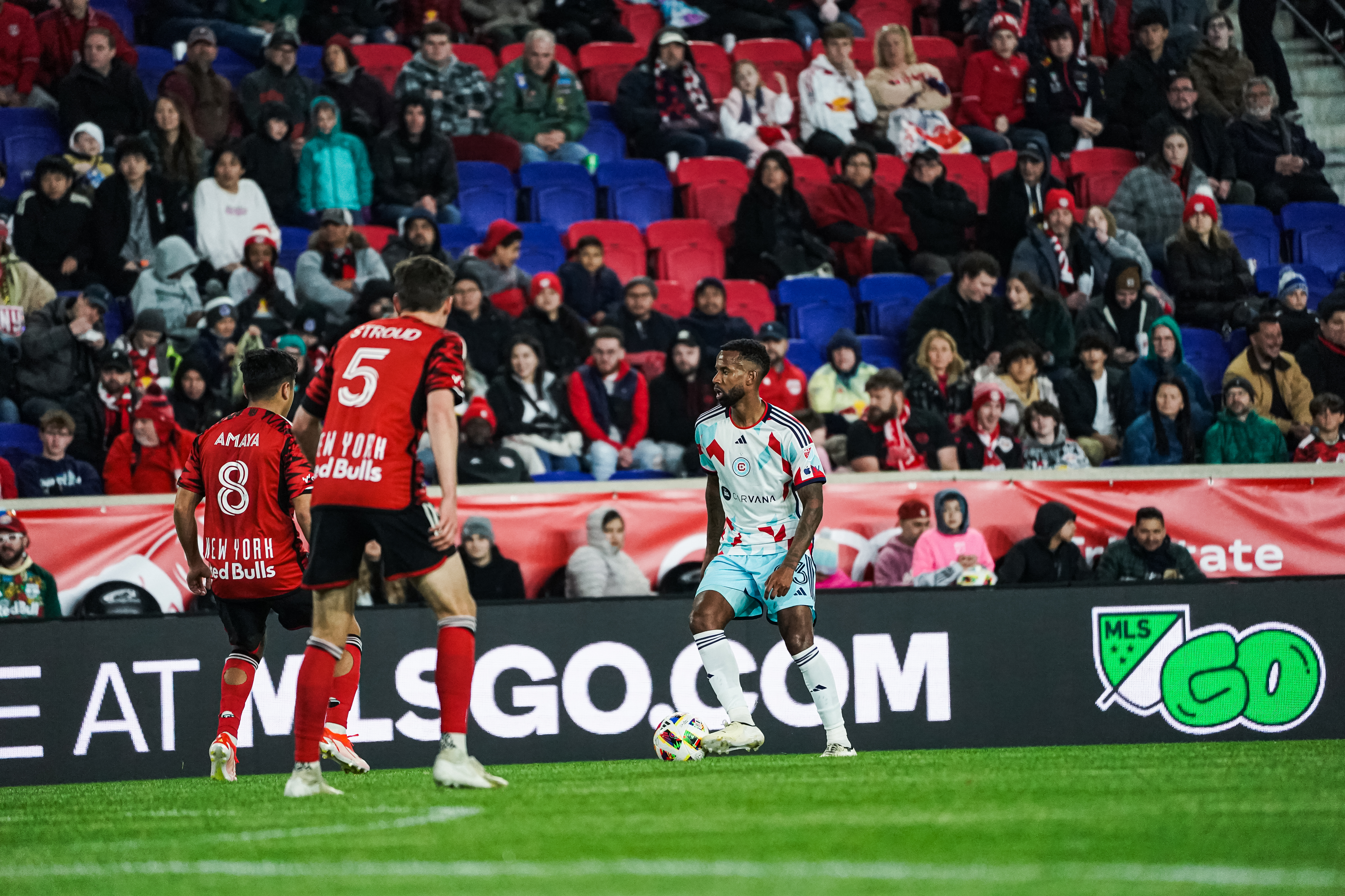 Kellyn Acosta plays the against New York Red Bulls palyers during a soccer game