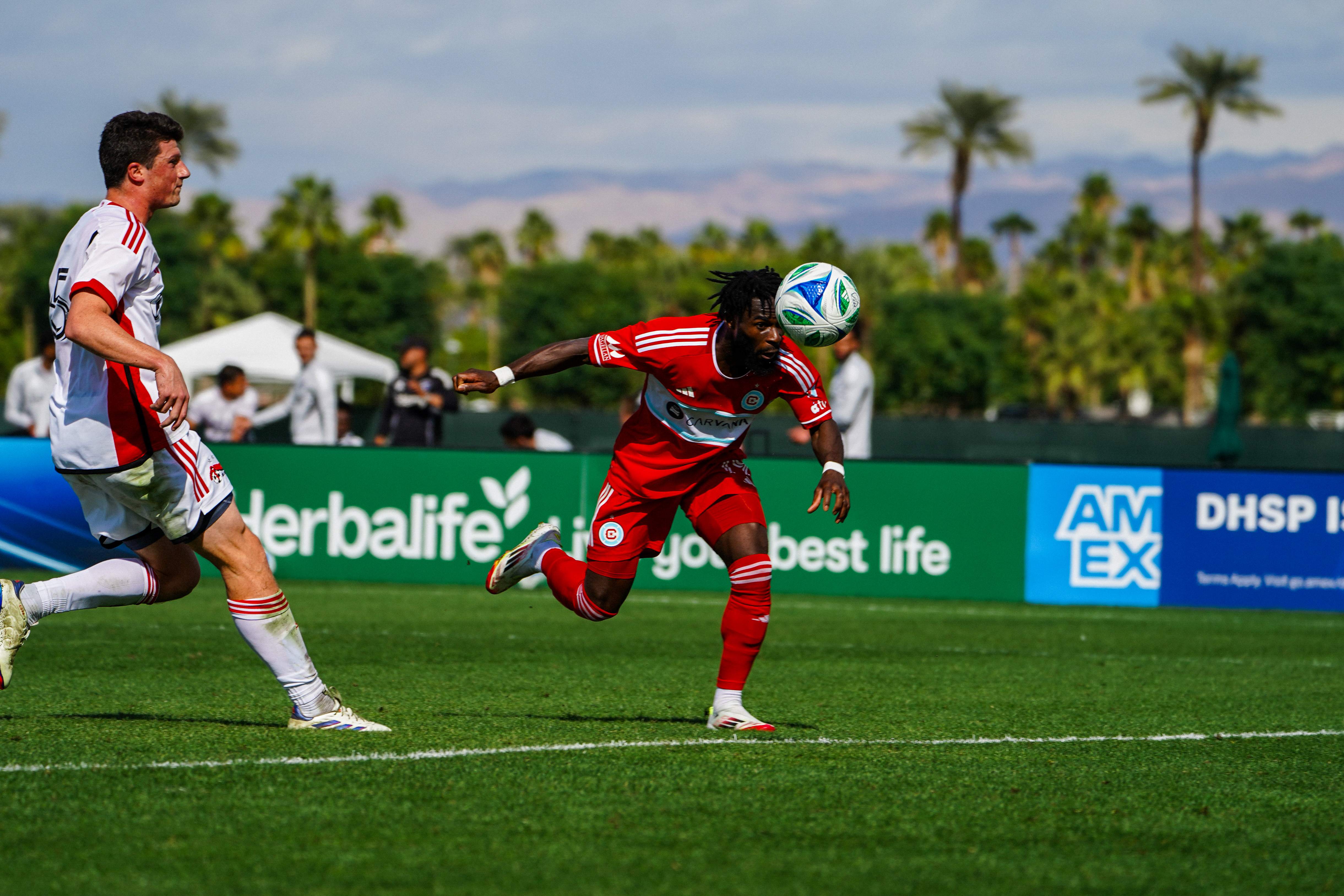 Jonathan Bamba heads the ball in preseason during a soccer game