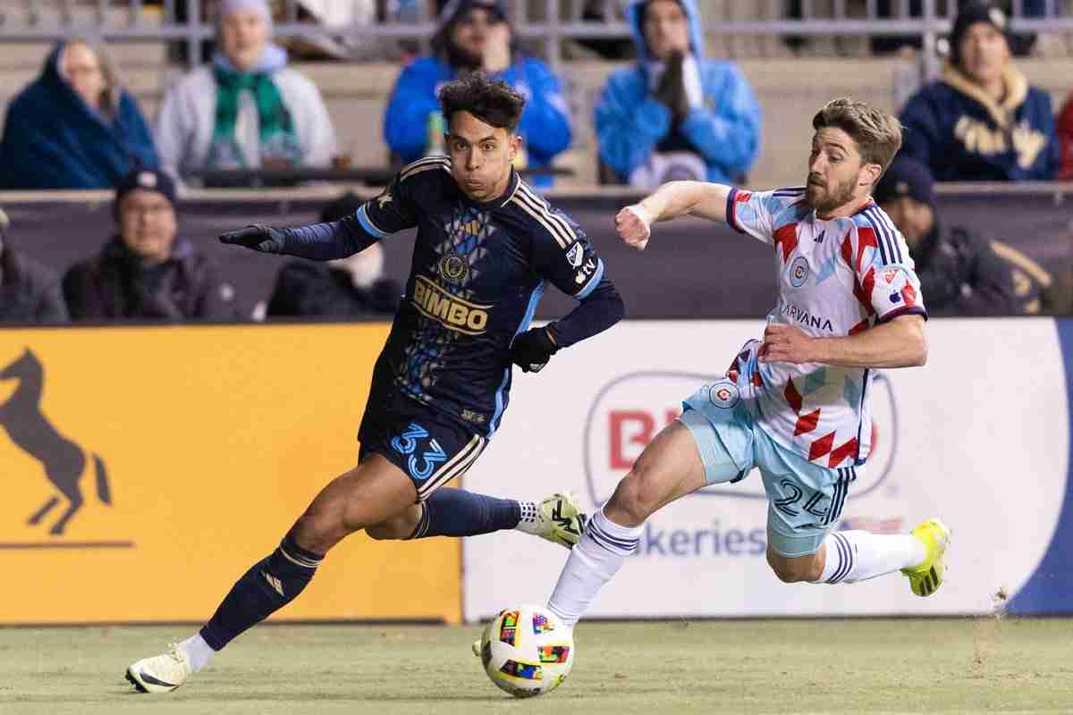 Feb 24, 2024; Philadelphia, Pennsylvania, USA; Philadelphia Union midfielder Quinn Sullivan (33) controls the ball past Chicago Fire FC midfielder Jonathan Dean (24) during the second half at Subaru Park. 