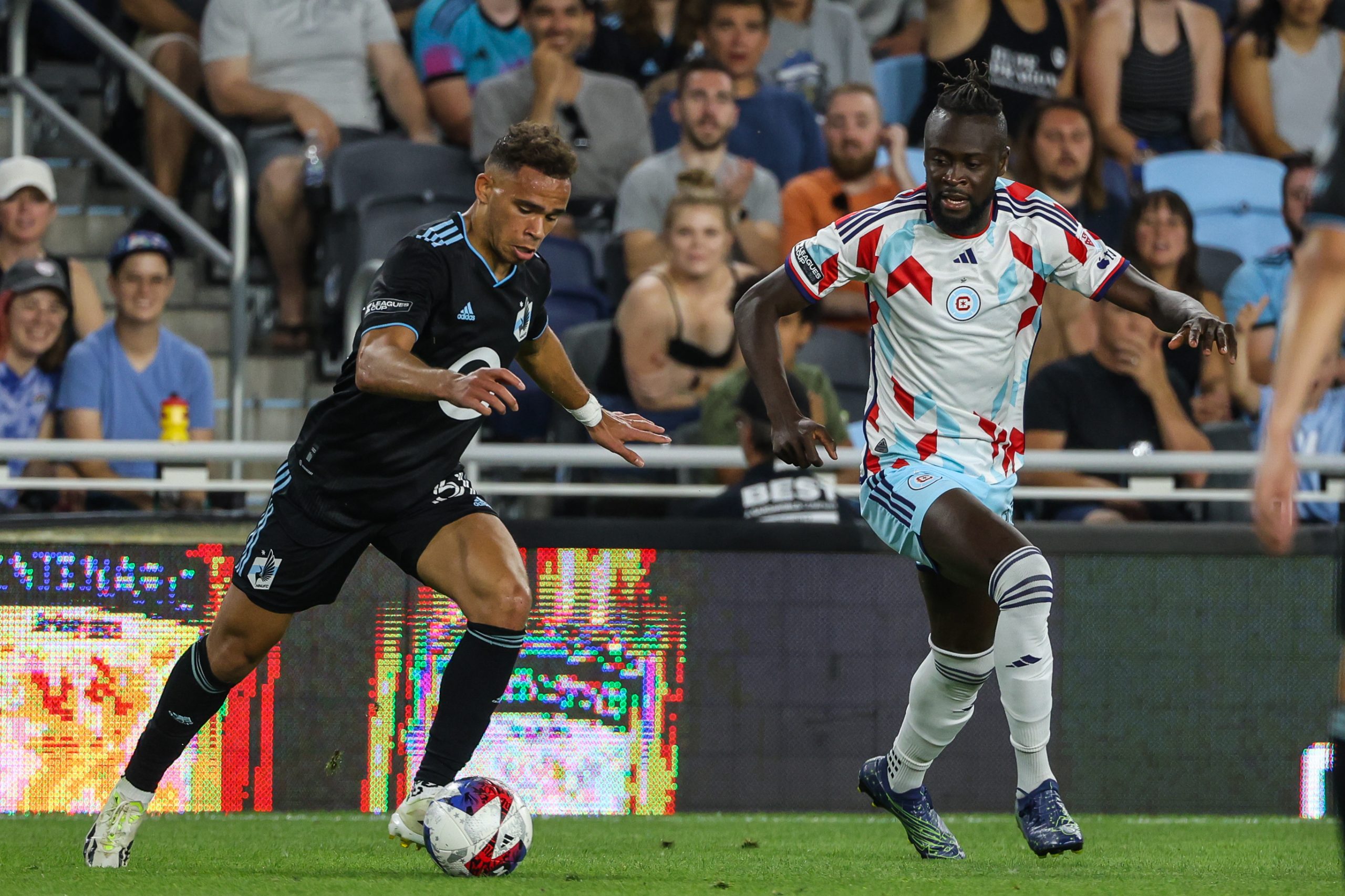 Jul 27, 2023; Saint Paul, MN, USA; Minnesota United midfielder Hassani Dotson (31) controls the ball while Chicago Fire forward Kei Kamara (23) defends during the second half at Allianz Field. Mandatory Credit: 