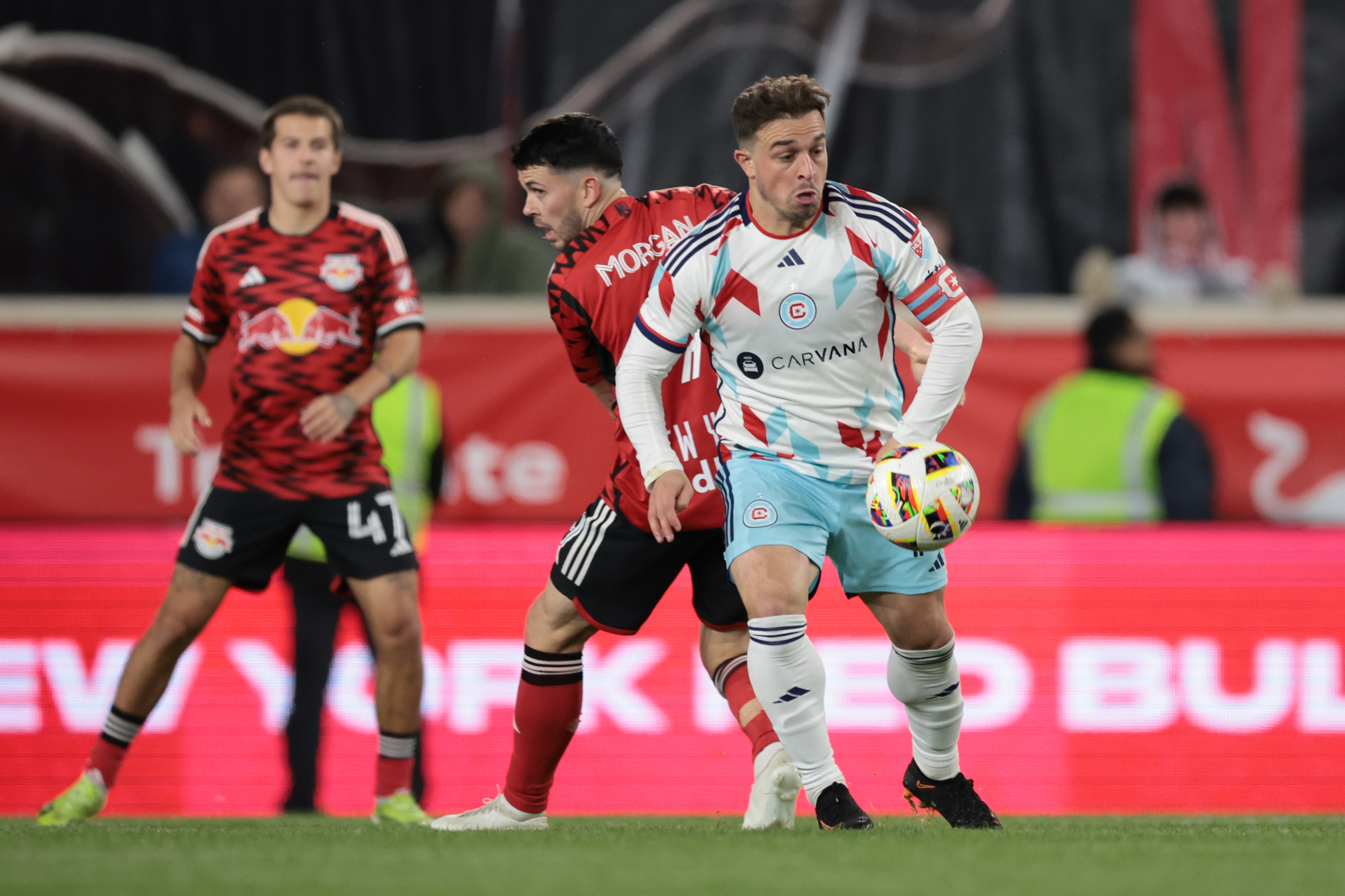 Apr 13, 2024; Harrison, New Jersey, USA; Chicago Fire FC midfielder Xherdan Shaqiri (10) battles for the ball against New York Red Bulls midfielder Lewis Morgan (9) during the first half at Red Bull Arena. 