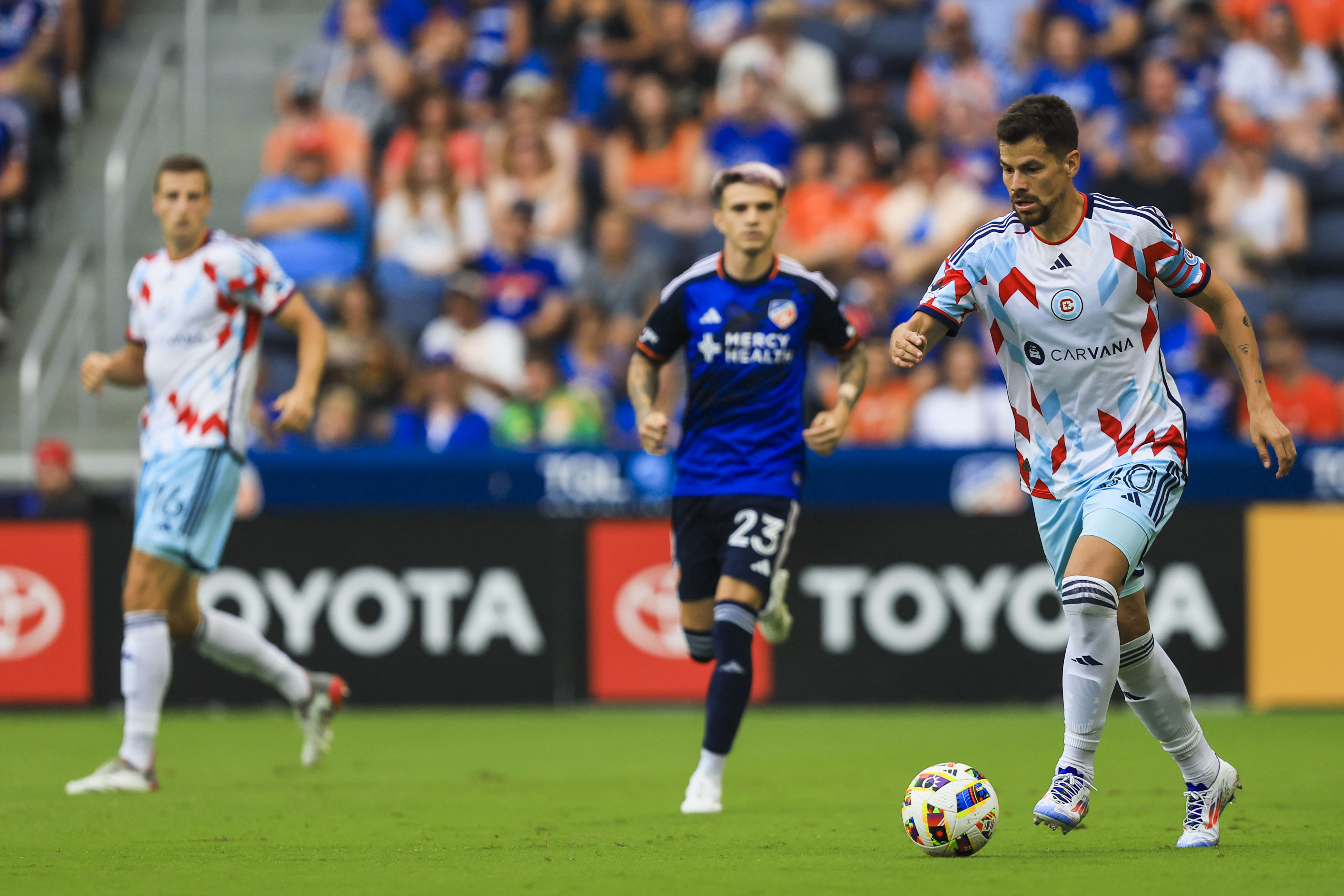 Jul 17, 2024; Cincinnati, Ohio, USA; Chicago Fire midfielder Gaston Gimenez (30) dribbles against FC Cincinnati in the first half at TQL Stadium.