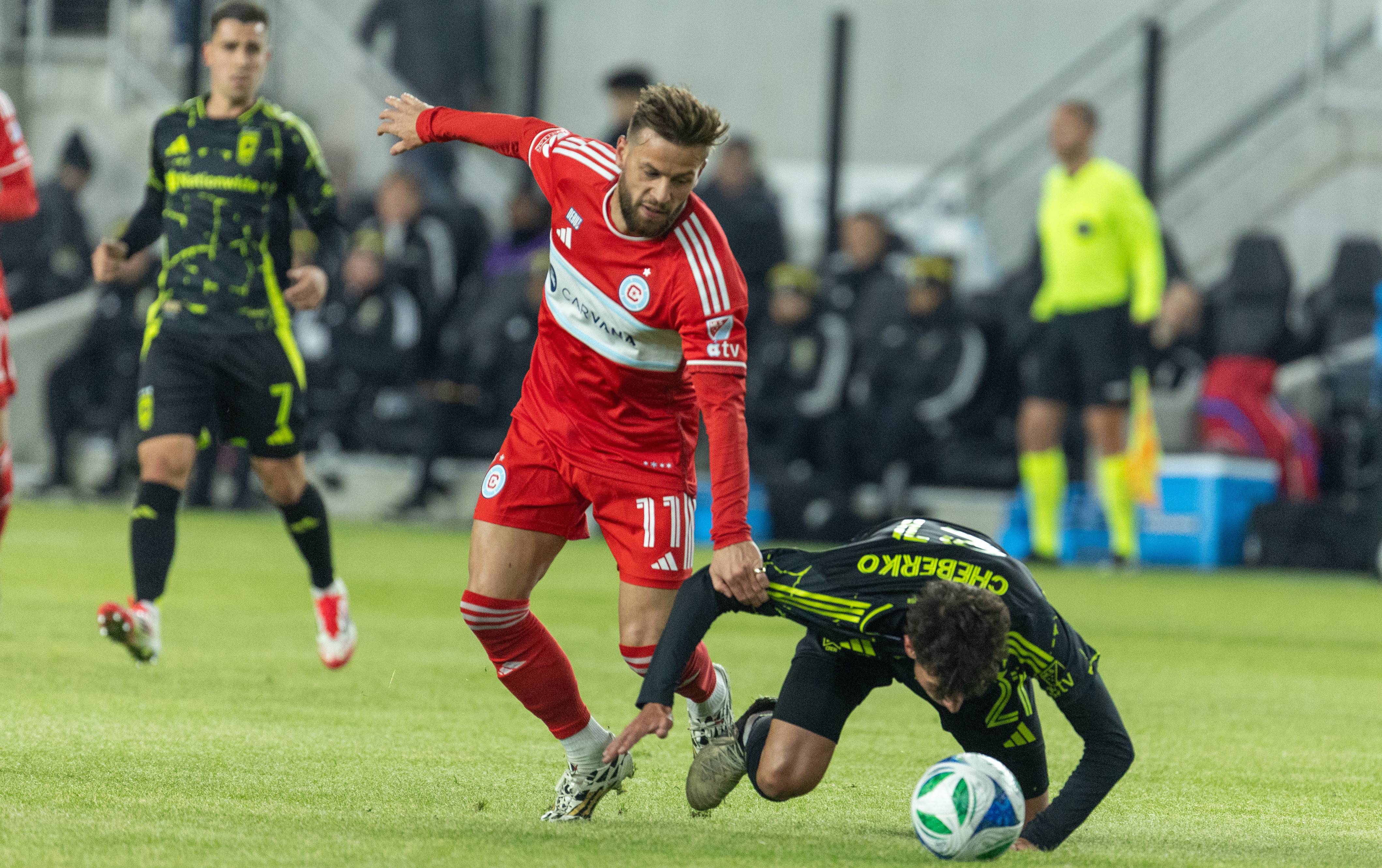 Feb 22, 2025; Columbus, Ohio, USA; Chicago Fire FC midfielder Philip Zinckernagel (11) dribbles the ball while Columbus Crew defender Yevhen Cheberko (21) )defends in the first half at Lower.com Field.