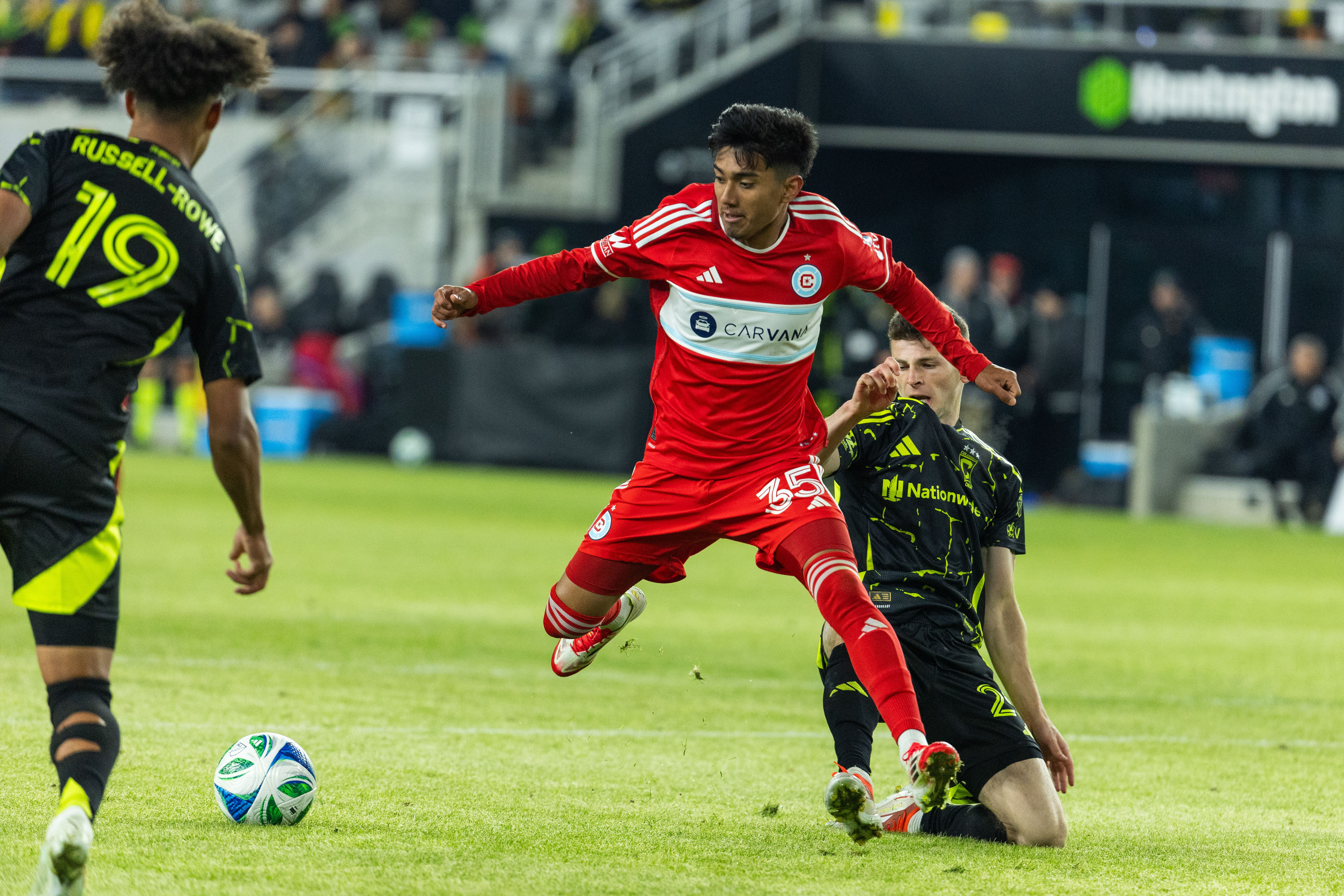 Feb 22, 2025; Columbus, Ohio, USA; Chicago Fire FC midfielder Sergio Oregel (35) dribbles the ball while Columbus Crew midfielder Sean Zawadzki (25) defends in the second half at Lower.com Field. Mandatory Credit: Trevor Ruszkowski-Imagn Images