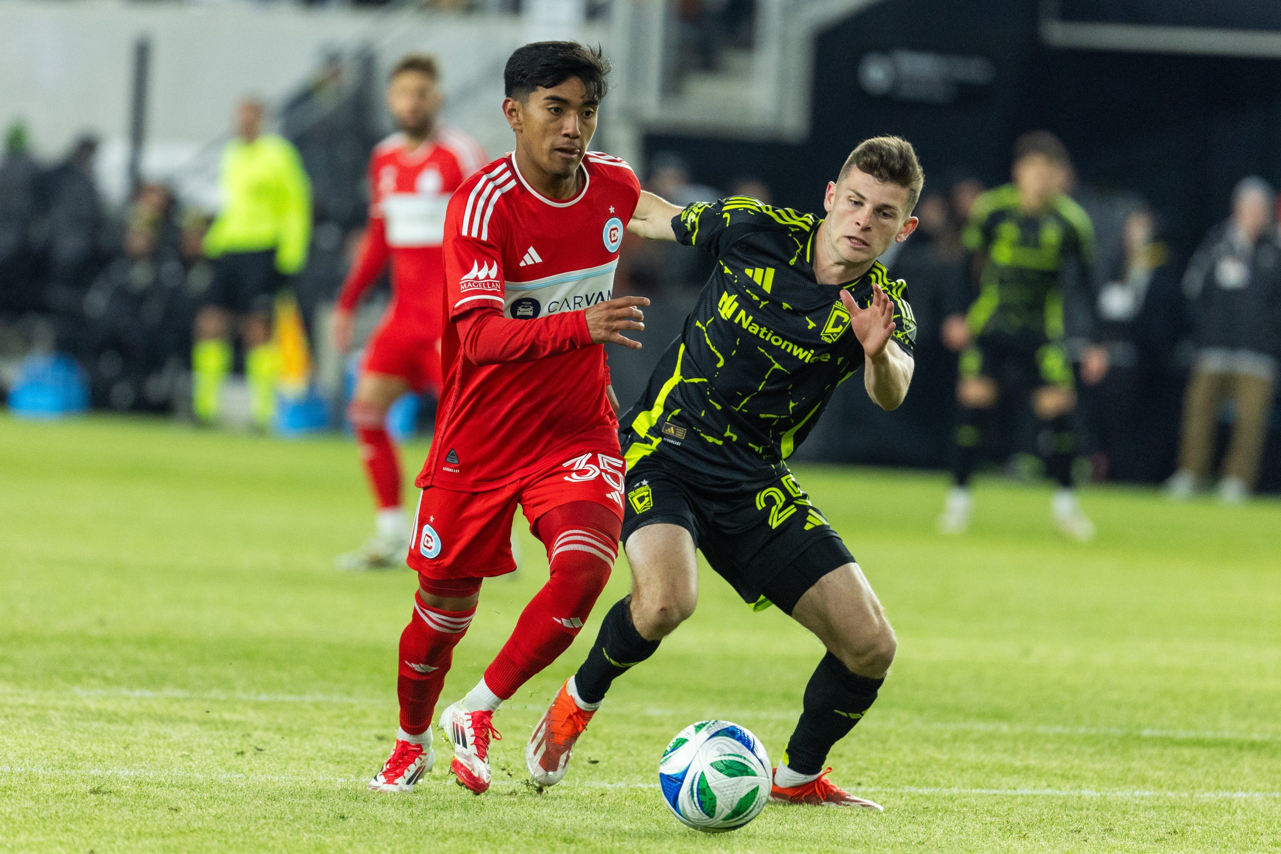 Feb 22, 2025; Columbus, Ohio, USA; Chicago Fire FC midfielder Sergio Oregel (35) dribbles the ball while Columbus Crew midfielder Sean Zawadzki (25) defends in the second half at Lower.com Field. Mandatory Credit: 