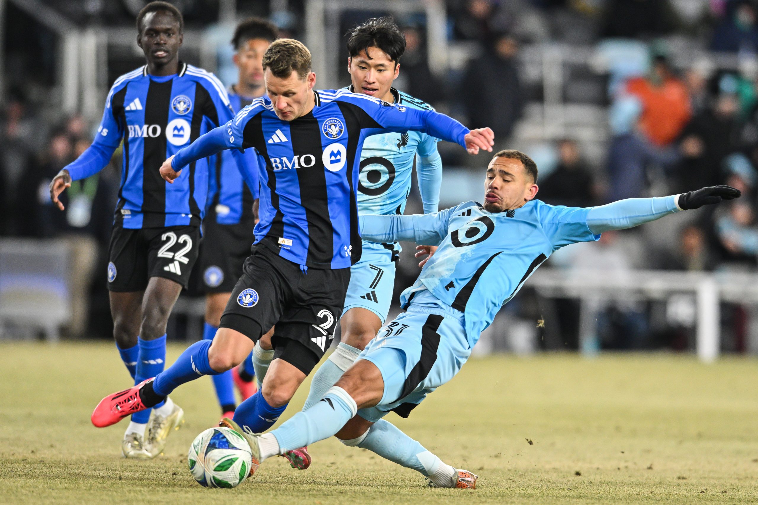 Mar 1, 2025; Saint Paul, Minnesota, USA; Minnesota United midfielder Hassani Dotson (31) and CF Montréal midfielder Fabian Herbers (21) battle for the ball during the second half at Allianz Field. Mandatory Credit: 
