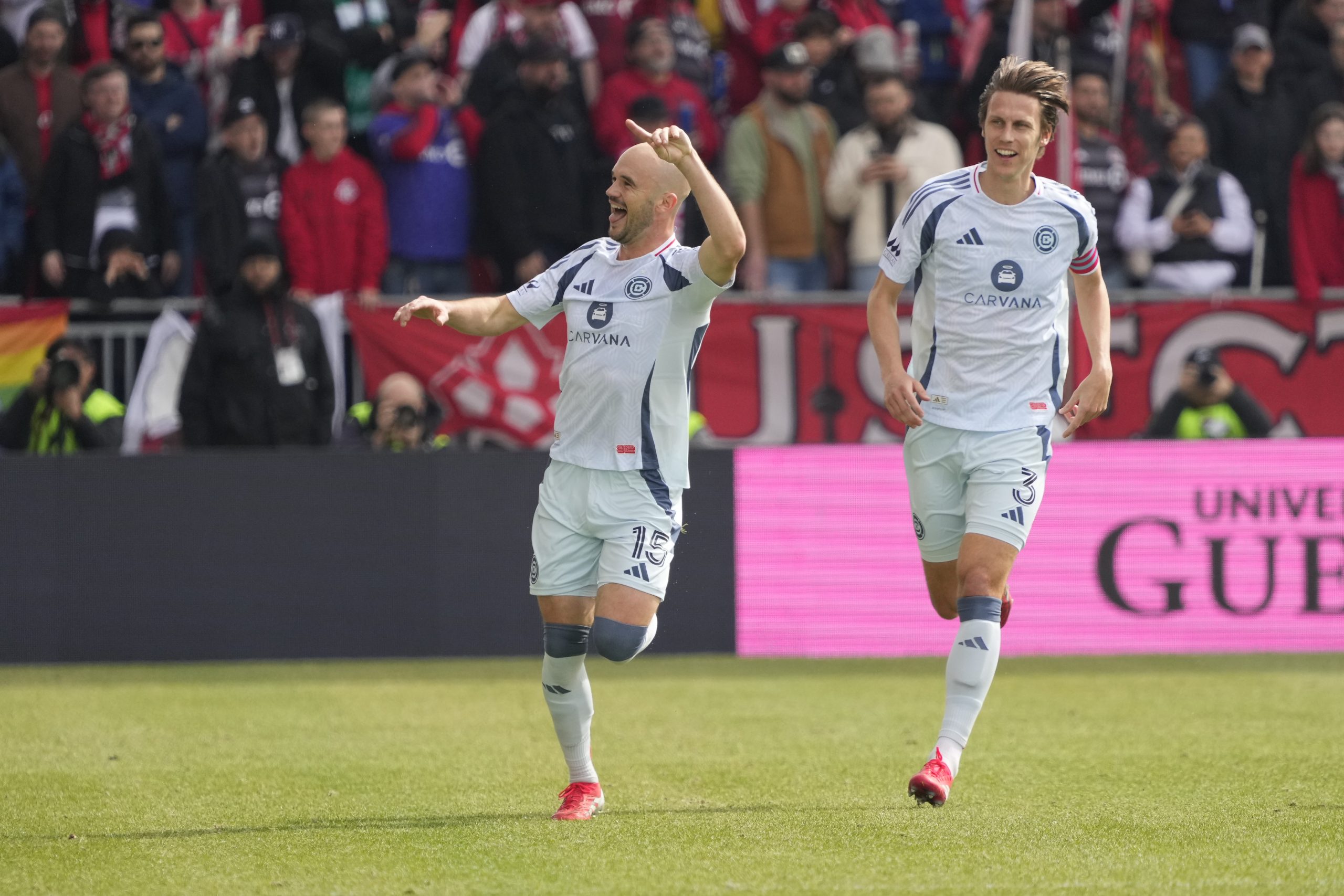 Mar 15, 2025; Toronto, Ontario, CAN; Chicago Fire defender Jack Elliott (3) celebrates with with goal scorer defender Andrew Gutman (15) during the first half against Toronto FC at BMO Field. Mandatory Credit: John E. Sokolowski-Imagn Images