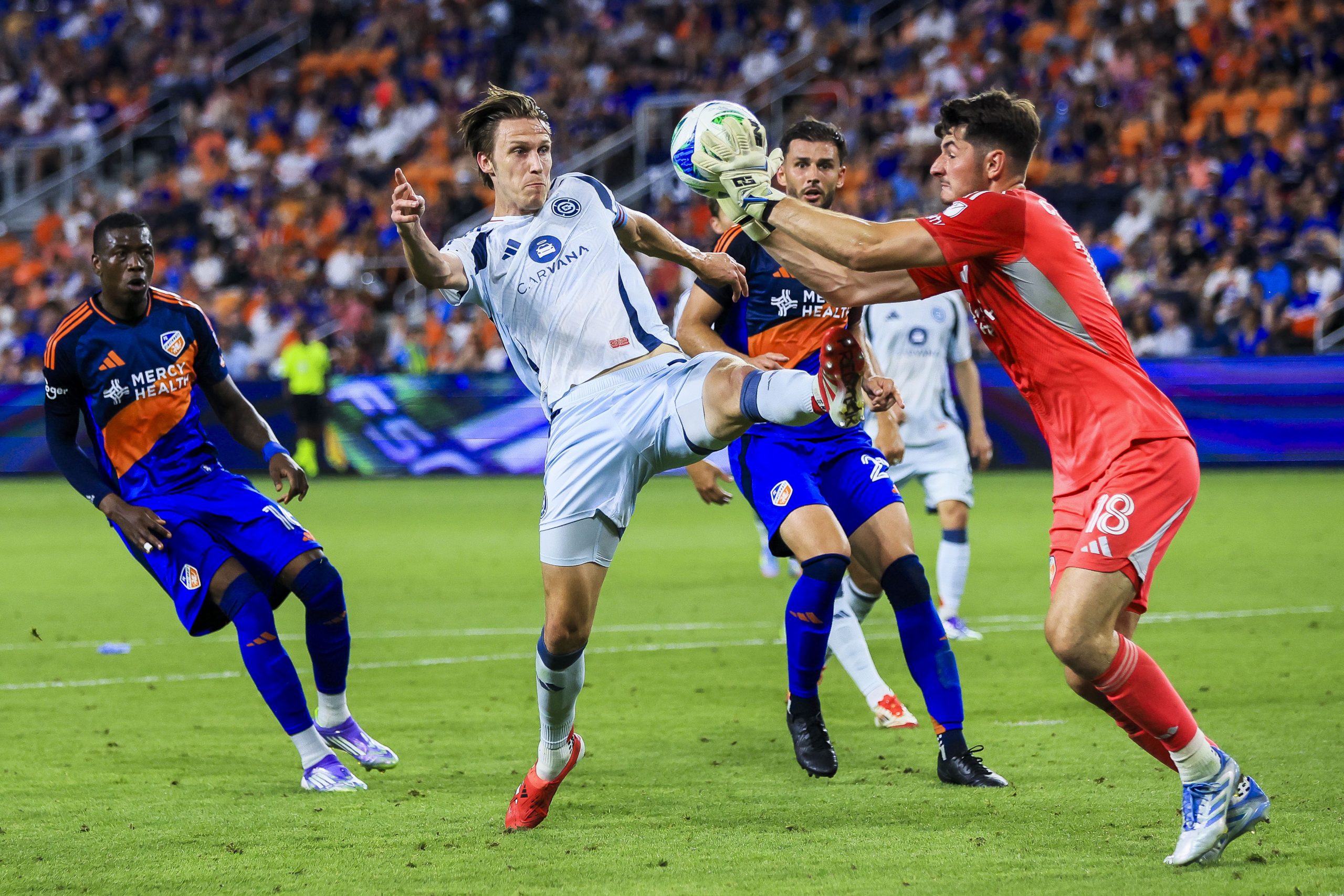 Jul 5, 2025; Cincinnati, Ohio, USA; FC Cincinnati goalkeeper Roman Celentano (18) makes a save against Chicago Fire FC defender Jack Elliott (3) in the second half at TQL Stadium. Mandatory Credit: Katie Stratman-Imagn Images