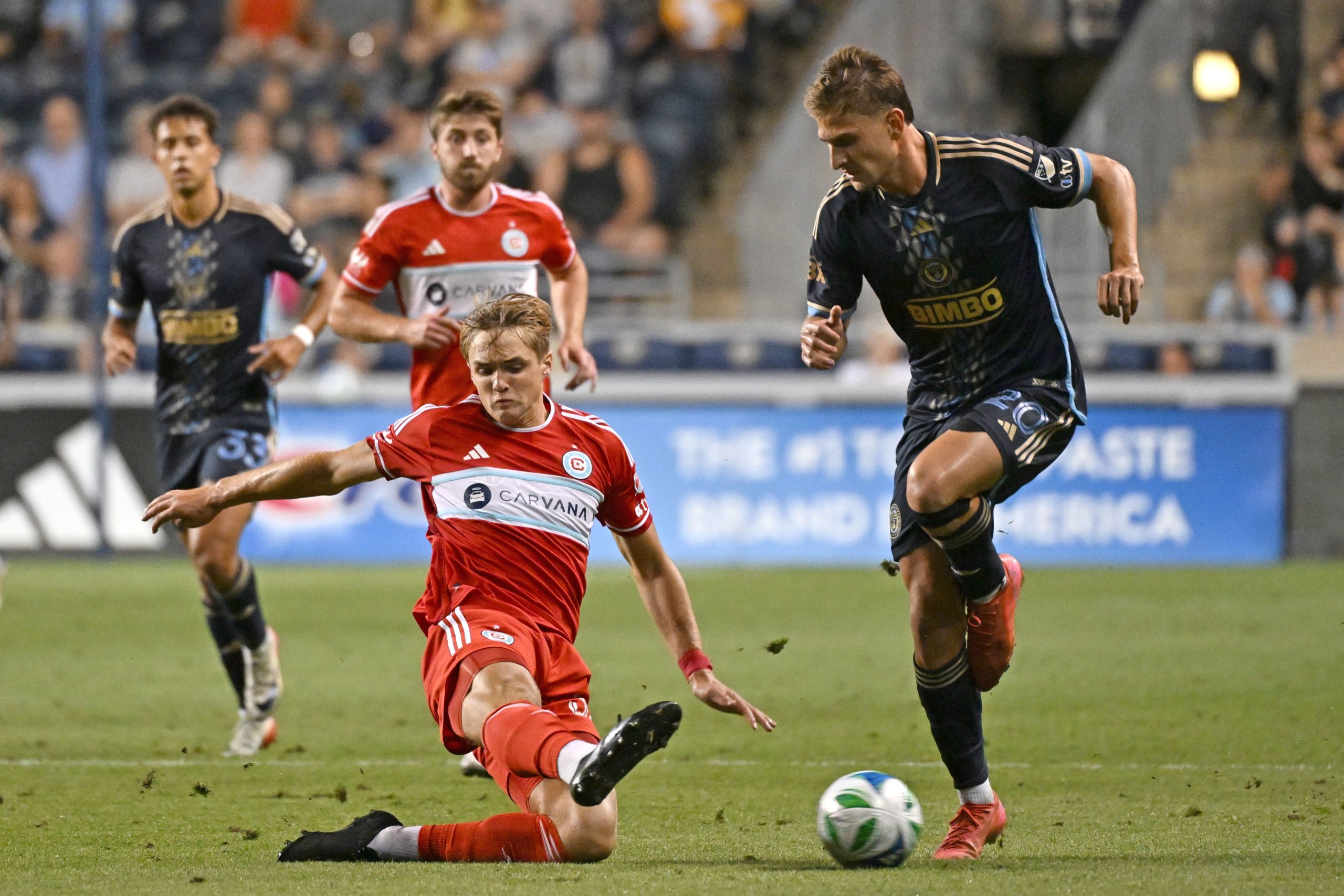 Aug 23, 2025; Chester, Pennsylvania, USA; Chicago Fire defender Christopher Cupps (38) and Philadelphia Union forward Bruno Damiani (20) battle for the ball during the second half at Subaru Park. Mandatory Credit: Eric Hartline-Imagn Images