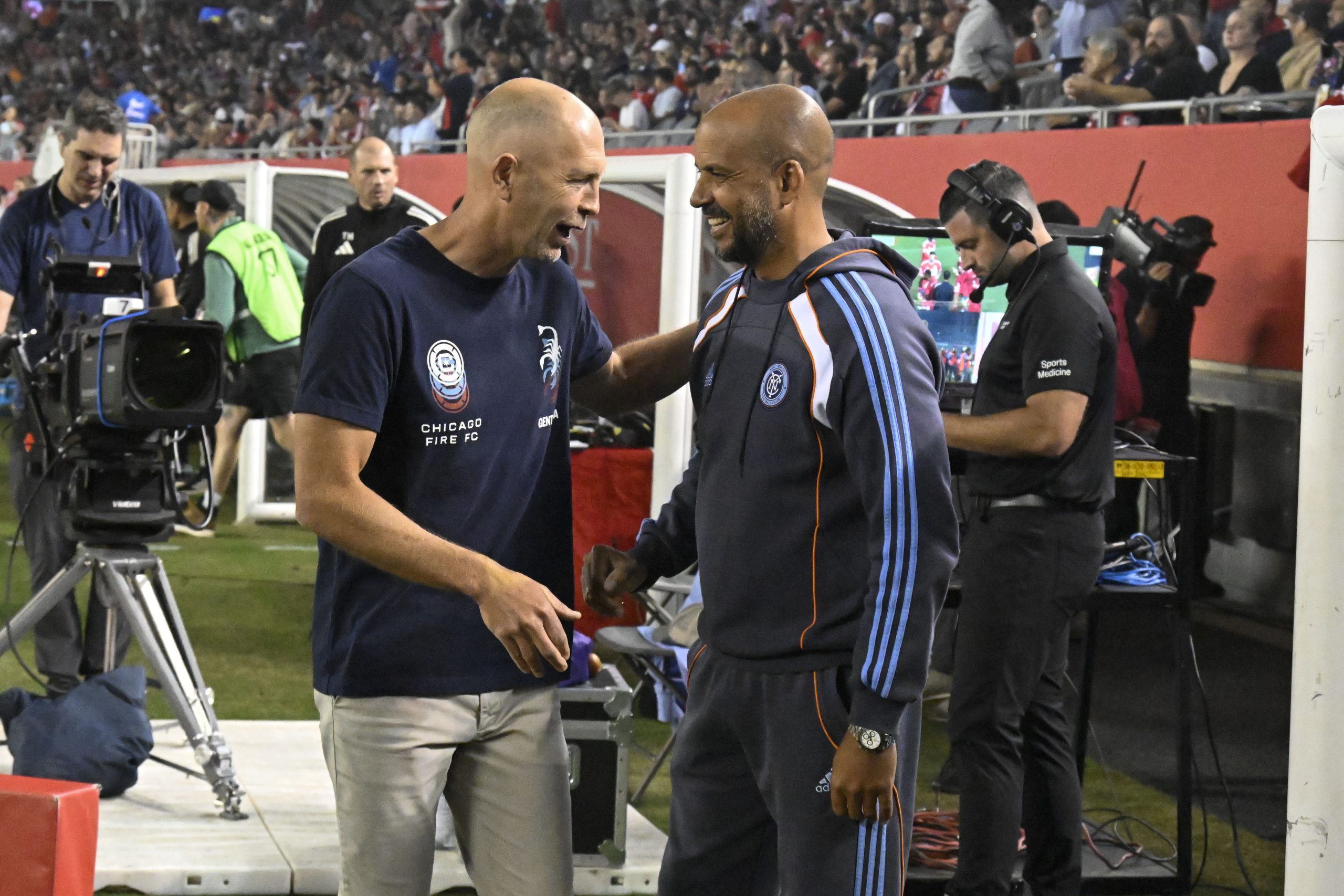 Sep 13, 2025; Chicago, Illinois, USA; New York City head coach Pascal Jansen, right, and Chicago Fire head coach Gregg Berhalter (left) before the game between the Chicago Fire and the New York City FC at Soldier Field.