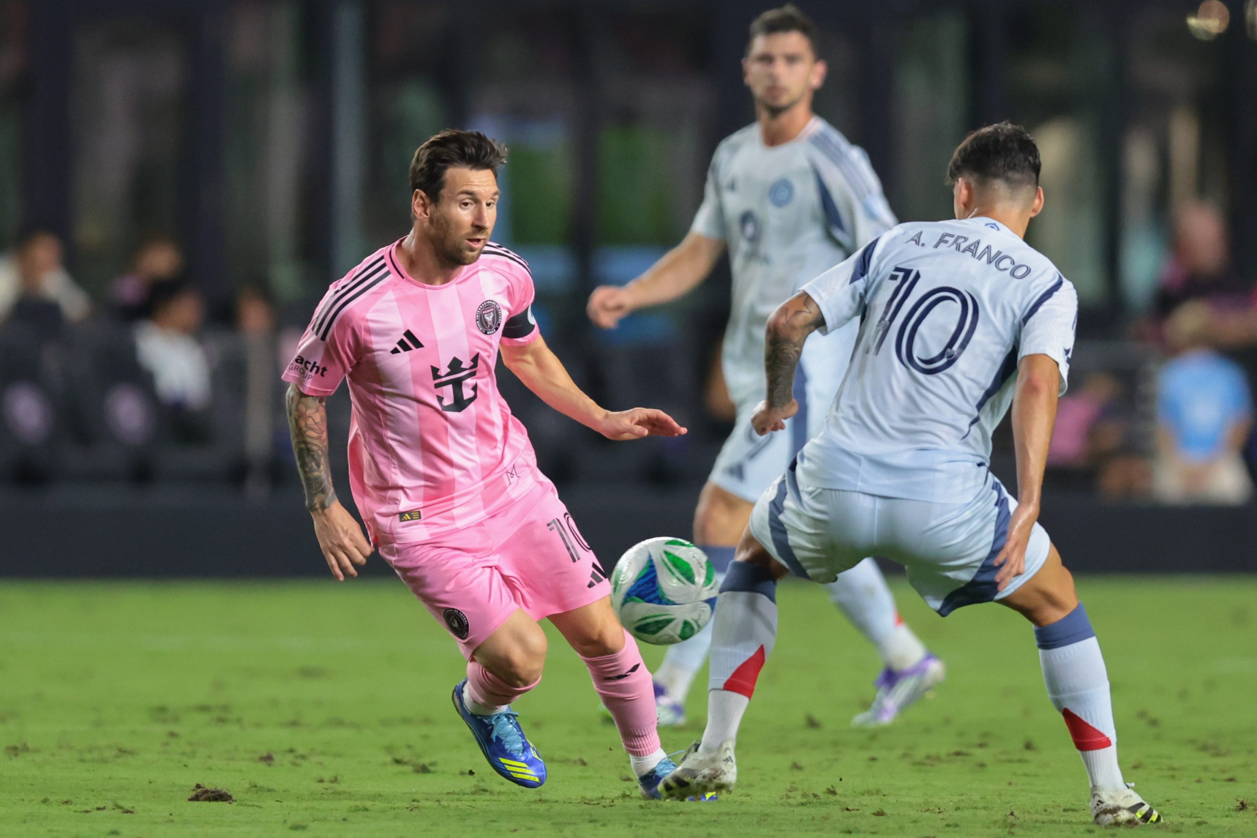 Sep 30, 2025; Fort Lauderdale, Florida, USA; Inter Miami CF forward Lionel Messi (10) passes the ball as Chicago Fire midfielder Andre Franco (10) during the first half at Chase Stadium. Mandatory Credit: Sam Navarro-Imagn Images