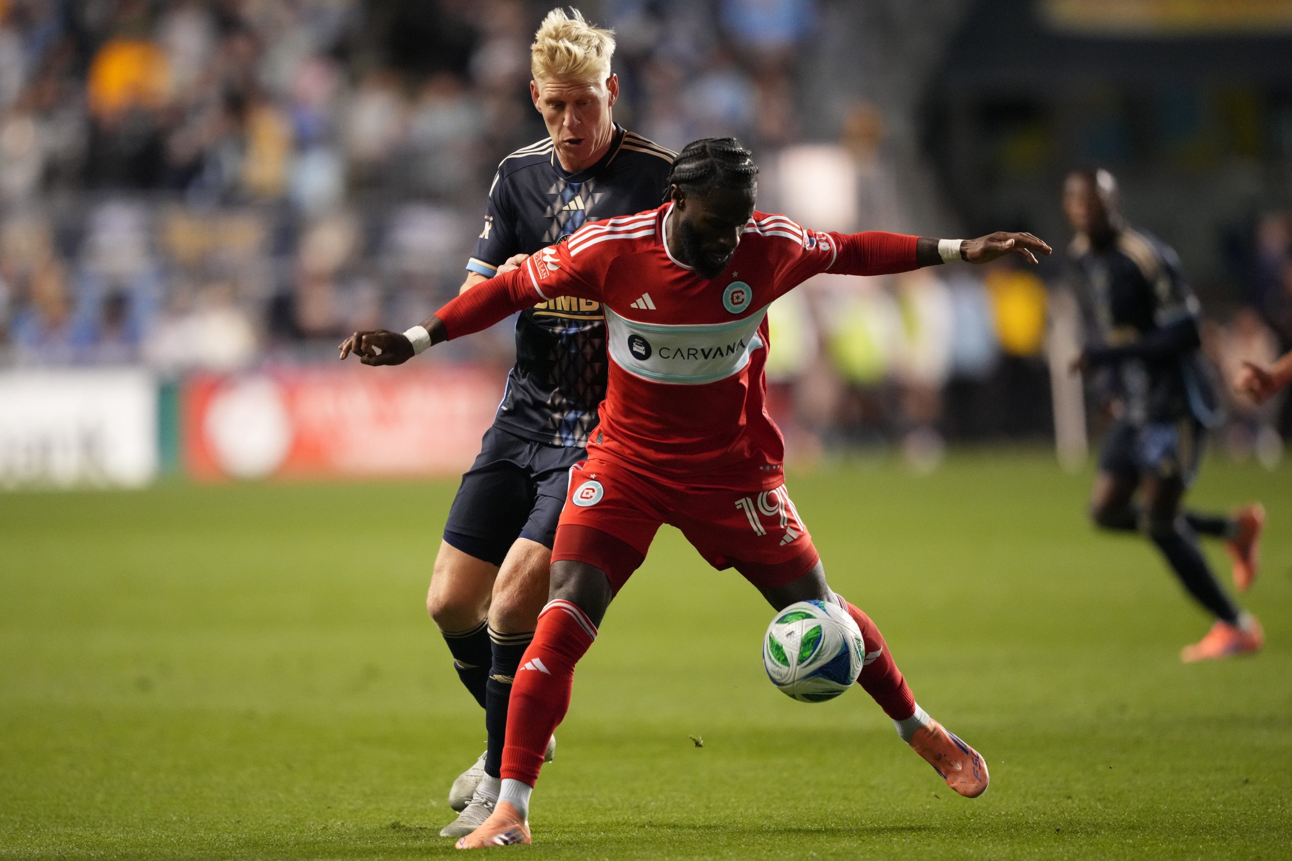 Oct 26, 2025; Chester, Pennsylvania, USA; Chicago Fire FC forward Jonathan Bamba (19) shields the ball from Philadelphia Union defender Jakob Glesnes (5) in the second half at Subaru Park. Mandatory Credit: Kyle Ross-Imagn Images