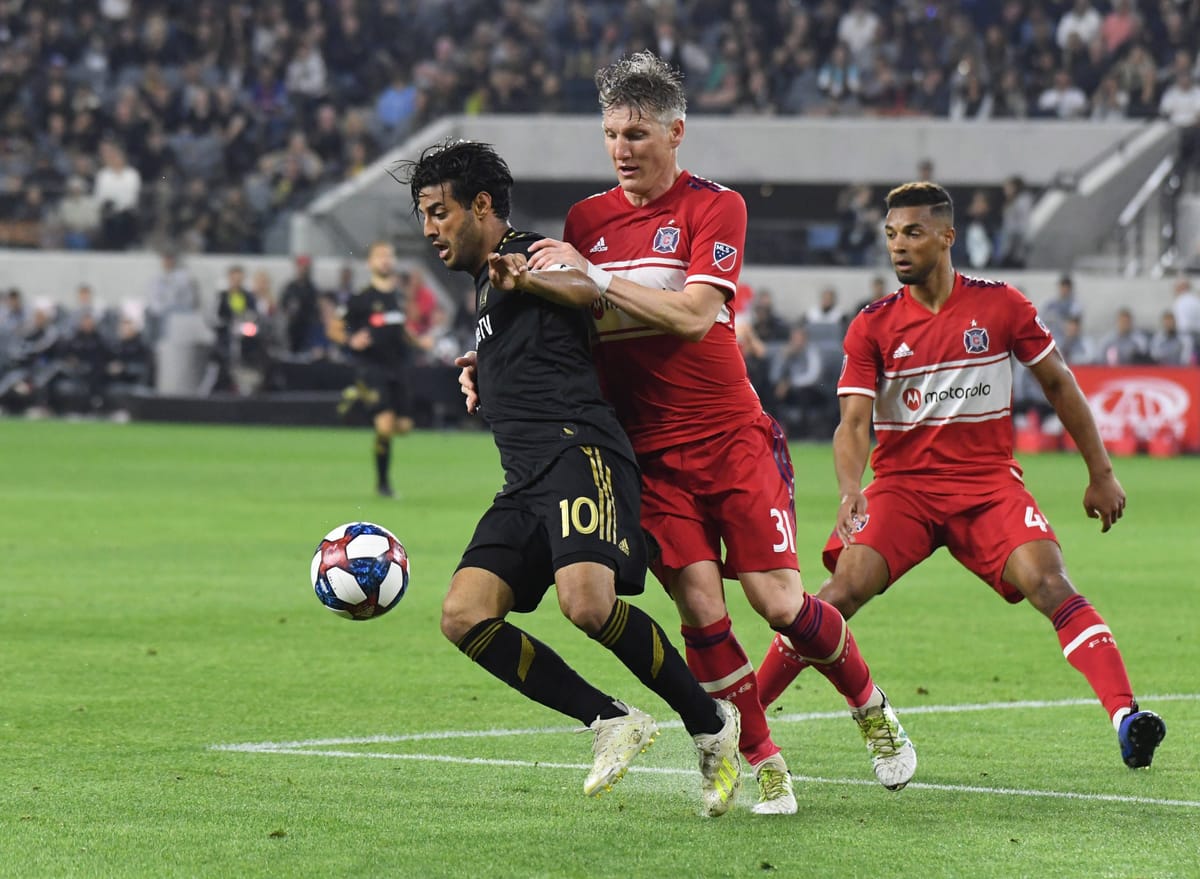May 4, 2019; Los Angeles, CA, USA; LAFC forward Carlos Vela (10) and Chicago Fire midfielder Bastian Schweinsteiger (31) batt