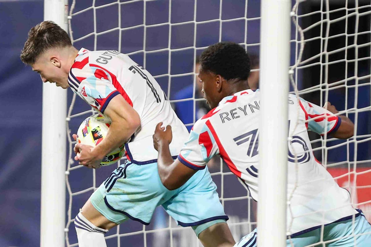 Chicago Fire soccer player Brian Gutierrez takes the ball out of the net after scoring a goal as Fire player Justin Reynolds