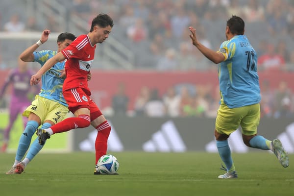 Chicago Fire FC player Brian Gutiérrez plays the ball as he's closed down by two Philadelphia Union defenders on June 25, 202